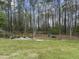 Spacious backyard with a fire pit and picnic area surrounded by mature trees at 2949 Tram Rd, Fuquay Varina, NC 27526
