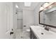 Neutral bathroom featuring a dark vanity, a soaking tub, shower with tile surround at 2949 Tram Rd, Fuquay Varina, NC 27526