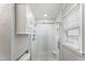 Bright bathroom featuring white subway tile and pebble floor in the shower and frosted glass shower door at 2949 Tram Rd, Fuquay Varina, NC 27526