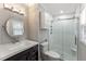 Bright bathroom with modern vanity, lighting, storage, and shower with glass door at 2949 Tram Rd, Fuquay Varina, NC 27526