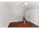 Bedroom featuring hardwood floors, closet, ceiling fan, and doorway to a hallway at 2949 Tram Rd, Fuquay Varina, NC 27526