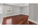 Bedroom features hardwood floors, a ceiling fan, two windows for natural light, and neutral wall color at 2949 Tram Rd, Fuquay Varina, NC 27526