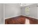 This bedroom boasts gleaming hardwood floors, a ceiling fan, and plenty of natural light at 2949 Tram Rd, Fuquay Varina, NC 27526
