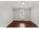 This bedroom offers beautiful hardwood floors, a ceiling fan and closet storage at 2949 Tram Rd, Fuquay Varina, NC 27526