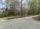 Long driveway leading to home and backyard with trees in background at 2949 Tram Rd, Fuquay Varina, NC 27526