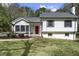Charming home with a red front door, black shutters, and well-maintained landscaping creating curb appeal at 2949 Tram Rd, Fuquay Varina, NC 27526