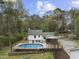 Aerial view of property with pool, screened porch, and mature landscaping at 2949 Tram Rd, Fuquay Varina, NC 27526
