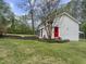 Exterior view of home with back yard, including garage and red door at 2949 Tram Rd, Fuquay Varina, NC 27526