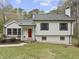 Charming home featuring a bright red front door and mature landscaping at 2949 Tram Rd, Fuquay Varina, NC 27526