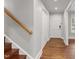 Hallway with hardwood flooring, white trim, and ample closet space at 2949 Tram Rd, Fuquay Varina, NC 27526