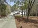 Charming home with red door, 3 car garage, long driveway, and mature trees at 2949 Tram Rd, Fuquay Varina, NC 27526