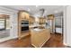 Gourmet kitchen with stainless steel appliances, kitchen island, and hardwood floors at 2949 Tram Rd, Fuquay Varina, NC 27526