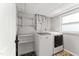 Bright laundry room featuring modern washer and dryer units and ample storage space at 2949 Tram Rd, Fuquay Varina, NC 27526