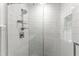 This stylish shower features subway tile, pebble flooring, and sleek fixtures at 2949 Tram Rd, Fuquay Varina, NC 27526
