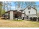 Expansive backyard featuring a covered patio with outdoor seating, lush greenery, and a charming fence at 302 Rutherglen Dr, Cary, NC 27511