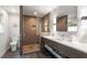 Bathroom featuring a shower with glass door, modern vanity with storage, and stone floors at 302 Rutherglen Dr, Cary, NC 27511