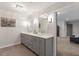This bathroom features a double sink vanity, modern lighting and fixtures, and an open doorway to another room at 302 Rutherglen Dr, Cary, NC 27511