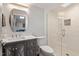 Modern bathroom with white marble countertop, glass shower and custom cabinets at 302 Rutherglen Dr, Cary, NC 27511