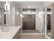 Modern bathroom featuring a walk-in shower with glass doors and multiple shower heads and tiled walls at 302 Rutherglen Dr, Cary, NC 27511
