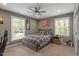 Bedroom featuring two large windows for natural light, ceiling fan, and soft carpet at 302 Rutherglen Dr, Cary, NC 27511