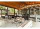 Stylish covered patio featuring a ceiling fan, comfortable seating, dining table and a grilling area at 302 Rutherglen Dr, Cary, NC 27511