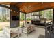 Inviting covered patio with modern furniture, a ceiling fan, outdoor lighting, TV and a convenient bar area at 302 Rutherglen Dr, Cary, NC 27511