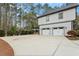 Spacious driveway leading to a two-car garage with a basketball hoop nearby at 302 Rutherglen Dr, Cary, NC 27511