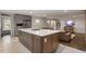 Open-concept kitchen with a large island and stainless steel appliances overlooking the living area at 302 Rutherglen Dr, Cary, NC 27511