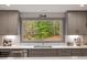 Modern kitchen with a large window offering views of the wooded backyard at 302 Rutherglen Dr, Cary, NC 27511