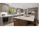 Modern kitchen with stainless steel appliances, a wine fridge, and island seating at 302 Rutherglen Dr, Cary, NC 27511