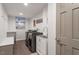 Bright laundry room with washer, dryer, sink, and shelving at 302 Rutherglen Dr, Cary, NC 27511