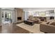 Open-concept living room with hardwood floors, a fireplace, and seamless kitchen access at 302 Rutherglen Dr, Cary, NC 27511