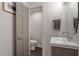 Well-lit powder room with modern vanity, fixture, and towel rack at 302 Rutherglen Dr, Cary, NC 27511
