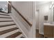 View of staircase with wood rail and stairs, and updated powder room at 302 Rutherglen Dr, Cary, NC 27511