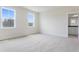 Bright bedroom featuring carpeted floors, neutral walls, two windows and ensuite bath at 304 Catheys Creek Cir, Wendell, NC 27591