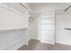 Walk-in closet with multiple shelves and clothing rods for organized storage at 304 Catheys Creek Cir, Wendell, NC 27591