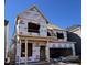 New home being constructed with lumber and blue sky; worker seen on second floor at 304 Catheys Creek Cir, Wendell, NC 27591