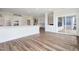 Open-concept living space flowing from the kitchen with sliding glass doors and wood floors at 304 Catheys Creek Cir, Wendell, NC 27591