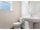 Modern powder room with a pedestal sink and luxury vinyl plank flooring at 304 Catheys Creek Cir, Wendell, NC 27591