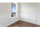 Bright room featuring luxury vinyl plank flooring, a window, and white wainscotting at 304 Catheys Creek Cir, Wendell, NC 27591