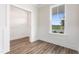 Bright room featuring luxury vinyl plank flooring, a window, and white wainscotting at 304 Catheys Creek Cir, Wendell, NC 27591