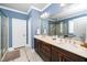 Bathroom featuring double sinks, a large mirror, and glass shower at 321 Third Ave, Knightdale, NC 27545