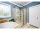 Spacious shower with glass surround, tiled walls, and decorative window at 321 Third Ave, Knightdale, NC 27545