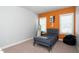 Bedroom with orange accent wall, light colored carpet, and neutral walls at 321 Third Ave, Knightdale, NC 27545