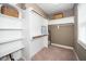 Walk-in closet with adjustable shelving, a mirror, and carpet flooring at 321 Third Ave, Knightdale, NC 27545