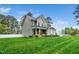 Charming two-story home with a manicured lawn, complemented by lush trees and a welcoming exterior at 321 Third Ave, Knightdale, NC 27545