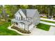 Stunning two-story home featuring a covered front porch, lush landscaping, and an attached two-car garage at 321 Third Ave, Knightdale, NC 27545