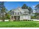 Beautiful two-story home featuring a covered porch, stone accents, and well-manicured lawn at 321 Third Ave, Knightdale, NC 27545