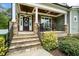 Inviting front porch with stone pillars, outdoor seating, and a charming entrance at 321 Third Ave, Knightdale, NC 27545