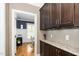 Hallway with granite countertops, dark cabinetry, and an open view into the adjacent office at 321 Third Ave, Knightdale, NC 27545